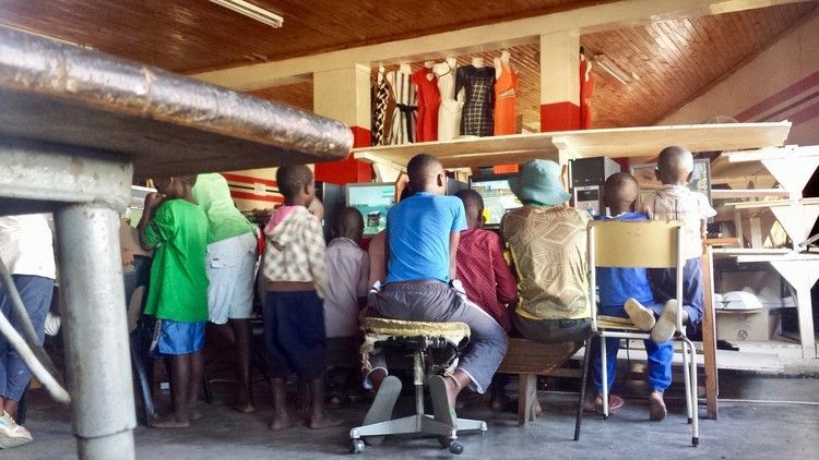 Kids in Zimbabwe loiter around an Internet cafe to play video games.